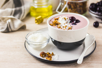 Granola smoothie bowl with frozen berries. Selective focus, space for text.