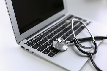 Obraz na płótnie Canvas Stethoscope lying on a laptop keyboard in a concept of online m
