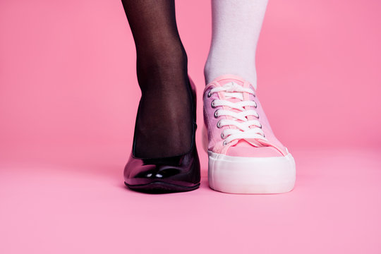 Cropped close-up view image concept photo of two different fit thin slim legs cozy comfort luxury luxurious elegant chic sporty comparison footgear isolated on pink pastel background