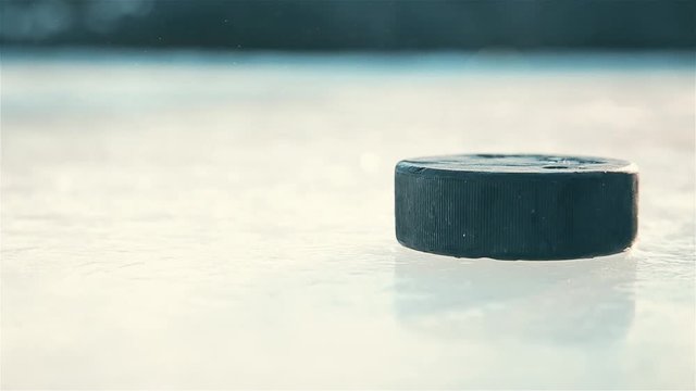 The approach of the black hockey puck on the ice rink HD 1920