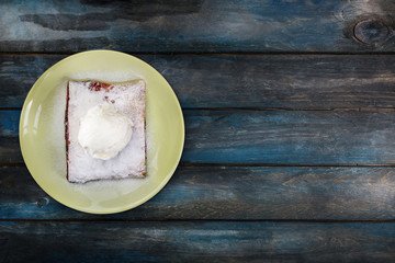Strudel with cherry , served on the ceramic plate with the ice cream.