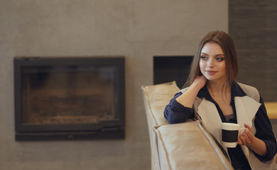 Beautiful young woman resting on sofa at home