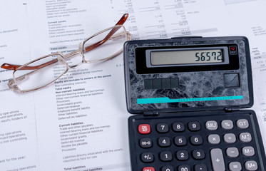 Calculator, glasses and business financial papers. Business concept