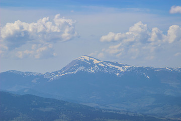Fototapeta premium Stunning landscape of a gentle morning sunrise on a warm summer morning over the line of the blue Carpathian mountains