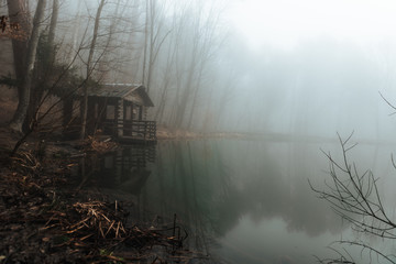 gazebo on a lake in a misty forest