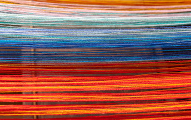 Colored threads of an ancient wooden loom