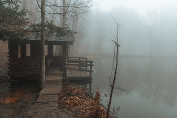 gazebo on a lake in a misty forest
