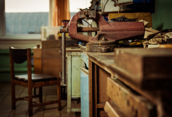 industrial room interior with old rusty vice and mess arround