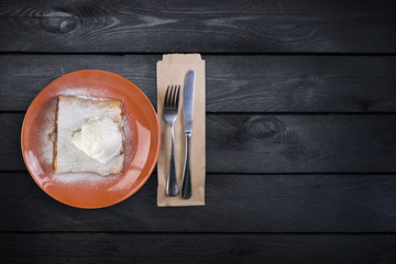 Strudel with an apple , served on the ceramic plate with the ice cream and the cutlery.