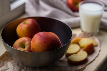 Preparation of whole and sliced apples and cake ingredients on craft papers