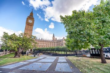 Westminster Palace and Big Ben with city gardens on a beautiful autumn day, London
