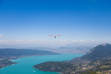 Man Hang-gliding over Mointains on a Hot Summer Day