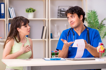 Fototapeta premium Young patient visiting doctor cardiologist