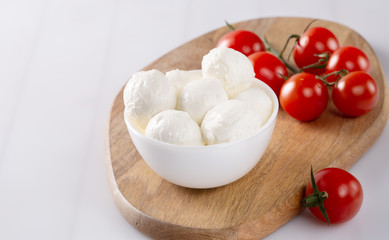 Fresh cherry tomatoes and mozzarella on white background