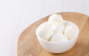 Fresh mozzarella in a bowl on white background