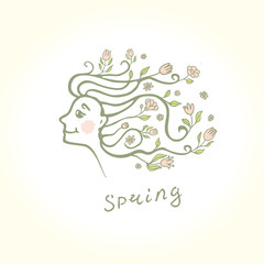 Profile of a beautiful girl with flowers in her hair. Spring flower hairstyle.