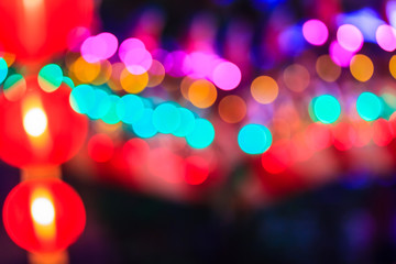 Chinese New Year Dragon Lights with Bokeh Background. Closeup of colorful dragon on night black background (soft blur with poor light and noise grain) during Chinese New Year festival.