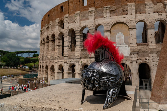 metallic gladiator helm on rome coliseum background