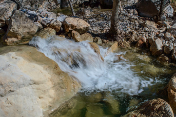 Waterfall flowing across rocks close - La Hoz