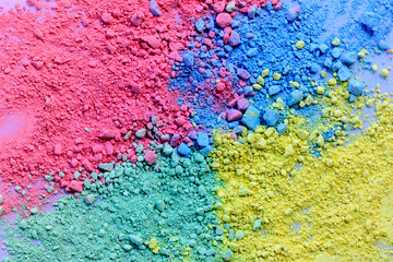 Colorful background of chalk powder. Multicolored dust particles splattered on white background.