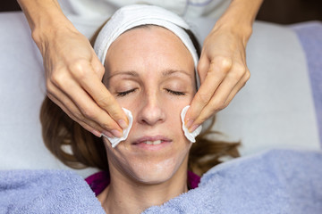 Fototapeta na wymiar Woman enjoying a facial cleansing treatment