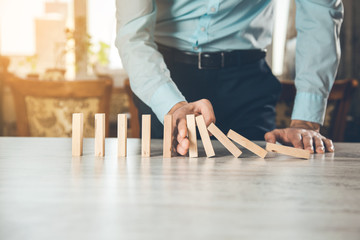 man hand wooden cubes on table