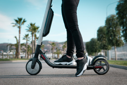 Woman On An Electric Scooter On The Road.