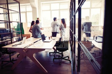 Achieving best results. Modern young man conducting a business presentation while standing in the board room.