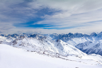 Fototapeta na wymiar Snowy Mountains in blue and white sky