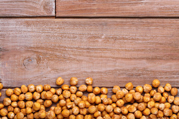 Roasted chickpeas on brown wooden table