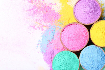 Colorful holi powder in bowls on white background