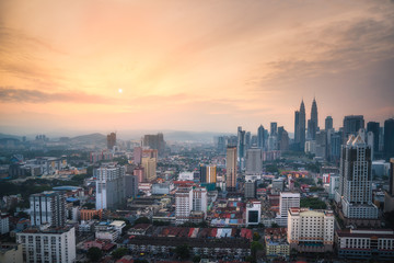 Panorama view of Kuala Lumpur business distric skyscraper with colorful sunrise sky background, Malaysia..