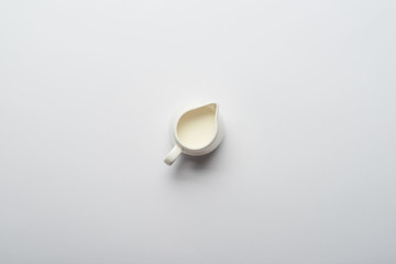 top view of white jar with fresh milk on grey background