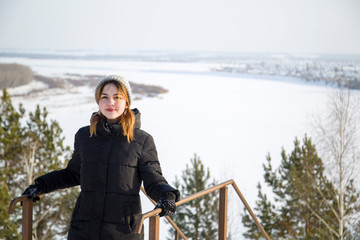 portrait of a young beautiful girl on top of a mountain