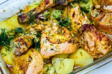 grilled chicken meat with potatoes sprinkled with greens