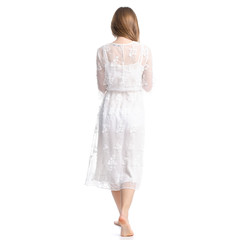 Woman in white dress summer spring laced goes on white background isolation, back view