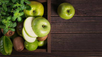 Set of green fruits for healthy diet and detox: apple, lime, kiwi, mango, carambola and mint.