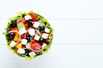Vegetable salad in bowl on wooden table