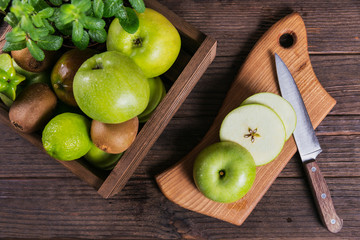Set of green fruits for healthy diet and detox: apple, lime, kiwi, mango, carambola and mint.