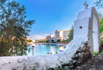 The lake Voulismeni in Agios Nikolaos,  a picturesque coastal town with colorful buildings around the port in the eastern part of the island Crete, Greece