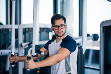 Young man exercising in the gym.