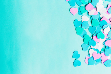 Top view blue paper background with small hearts with copy space for text, happy Valentine's day greetings. Mother's, birthday greeting card