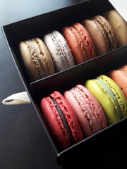 Colorful french macarons or macaroons in a beautiful gift box