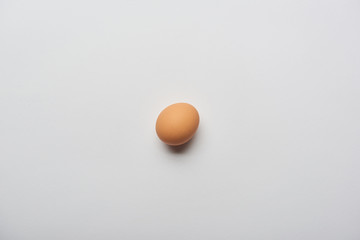 top view of organic brown egg on grey background