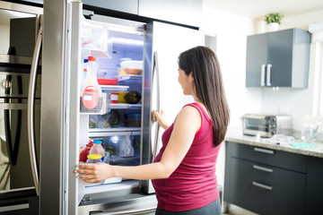 Fototapeta na wymiar Looking Into Refrigerator For Something To Eat