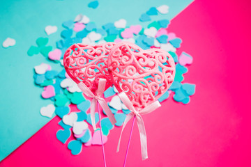 Flat lay of colorful hearts on pink and blue background, top view. Valentine's Day.