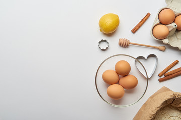 top view of bakery ingredients and dough molds on grey background