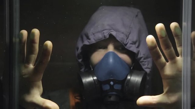 The guy in the gas mask closed himself in a transparent room HD 1920x1080