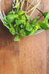 Mint. Bunch of Fresh green organic mint leaf on wooden table closeup.