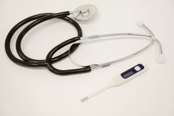 Pharmacy background on a white table. Tablets on a white background. Pills. Medicine and healthy. Close up of capsules. Stethoscope on a white wooden background. Copy space for a text.